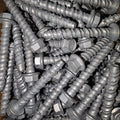Concrete screw bolt from Bolt Direct securely fixed into concrete surface, showing its threaded design and sturdy head.