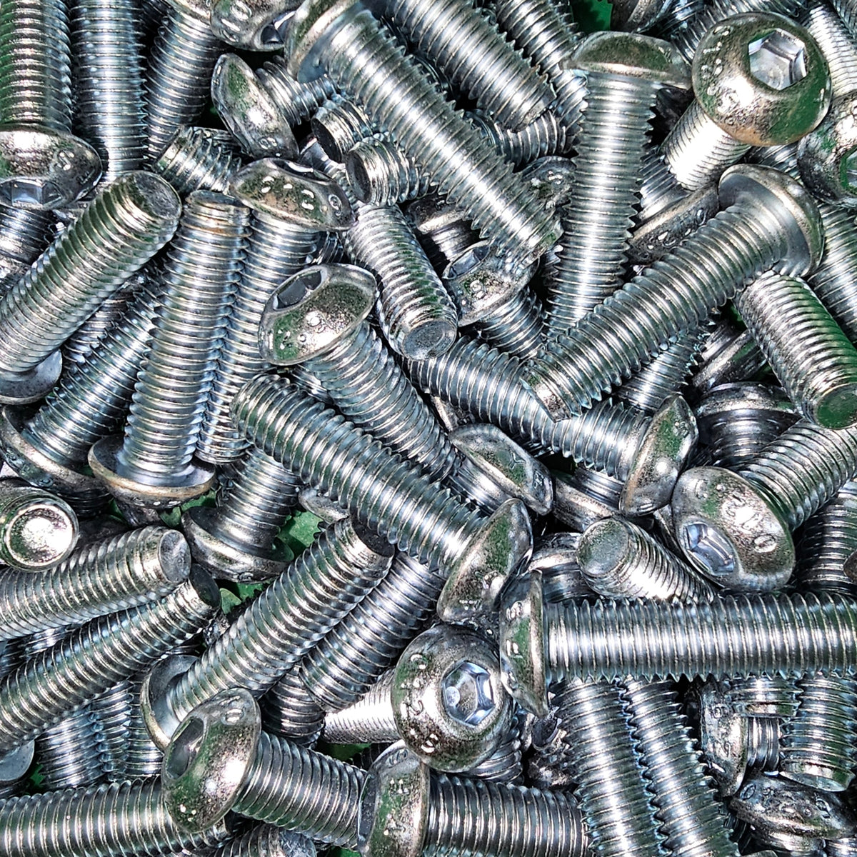 Zinc button socket screws by Bolt Direct, showing close-up of shiny, silver fasteners with a smooth, rounded head and threading.